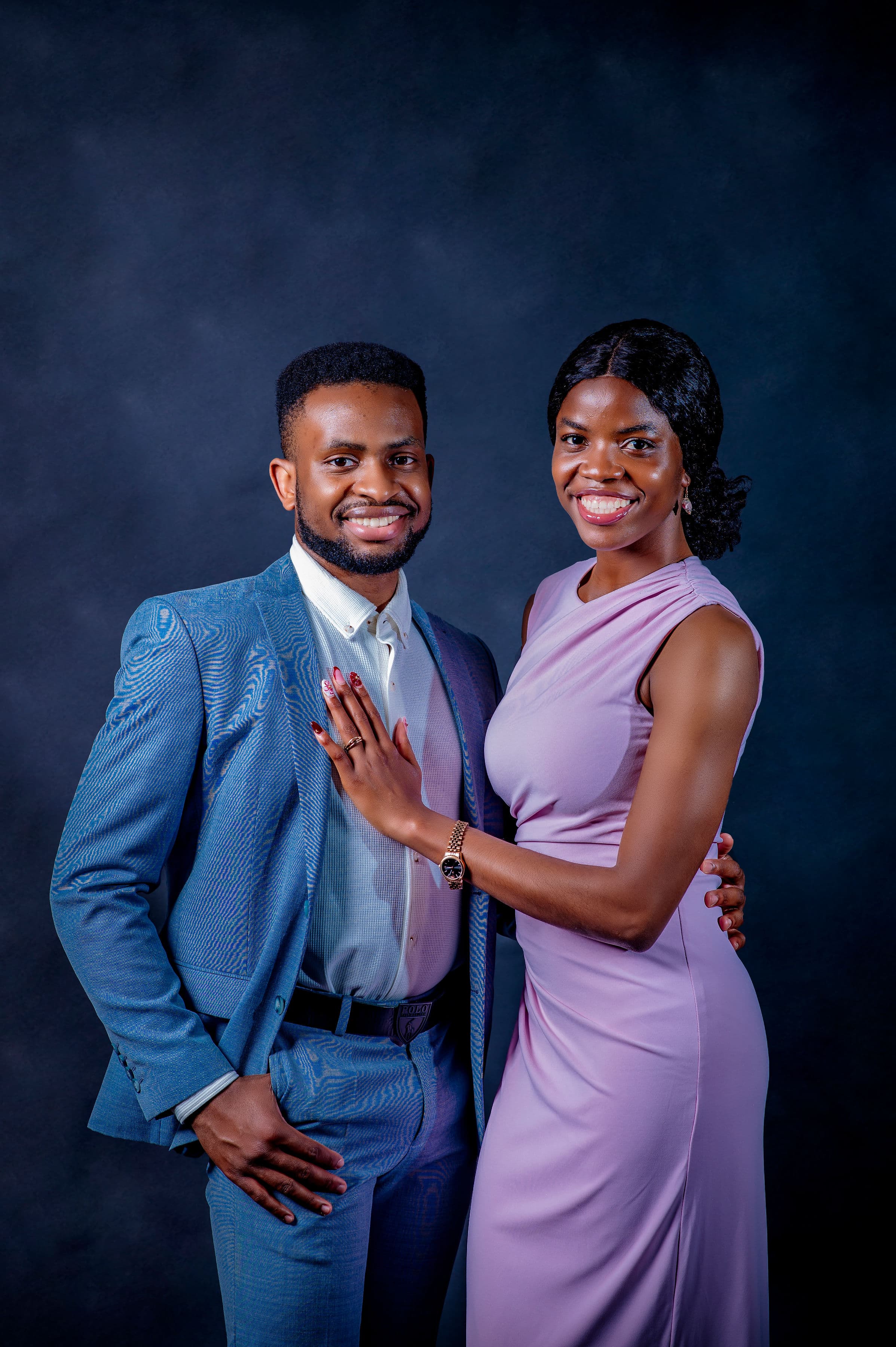 David in a blue suit and Esther in a lilac gown, her hand resting on his chest