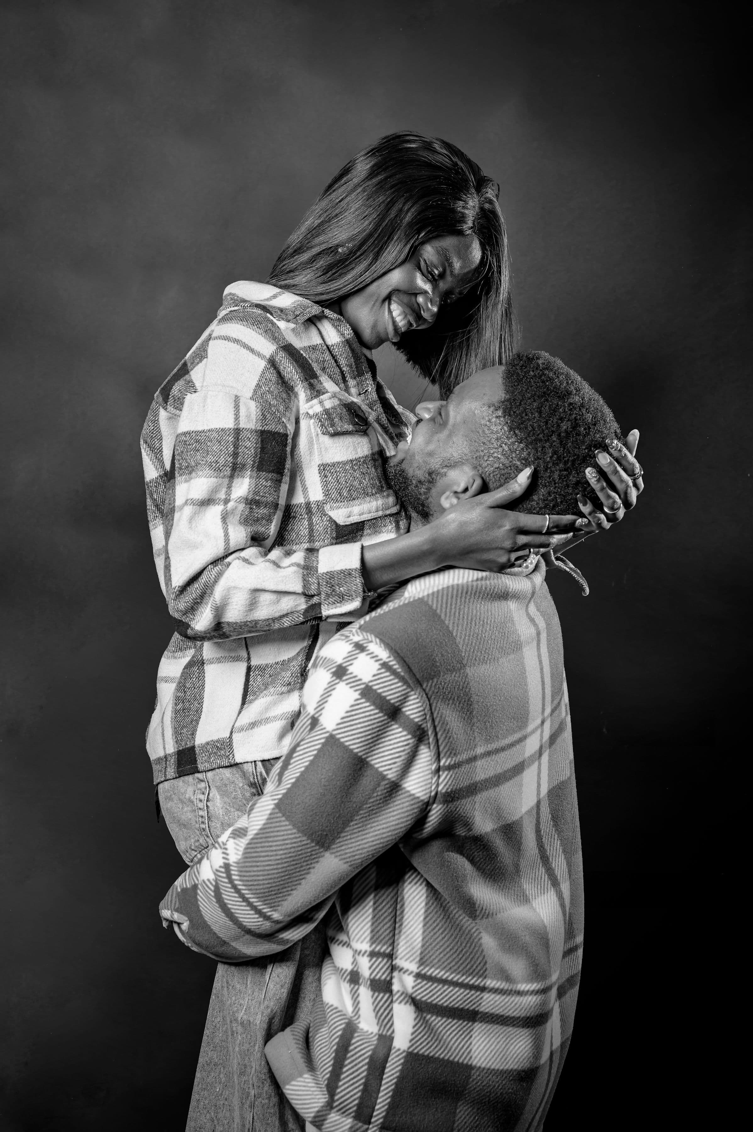 Black and white photo of David lifting Esther as they gaze at each other