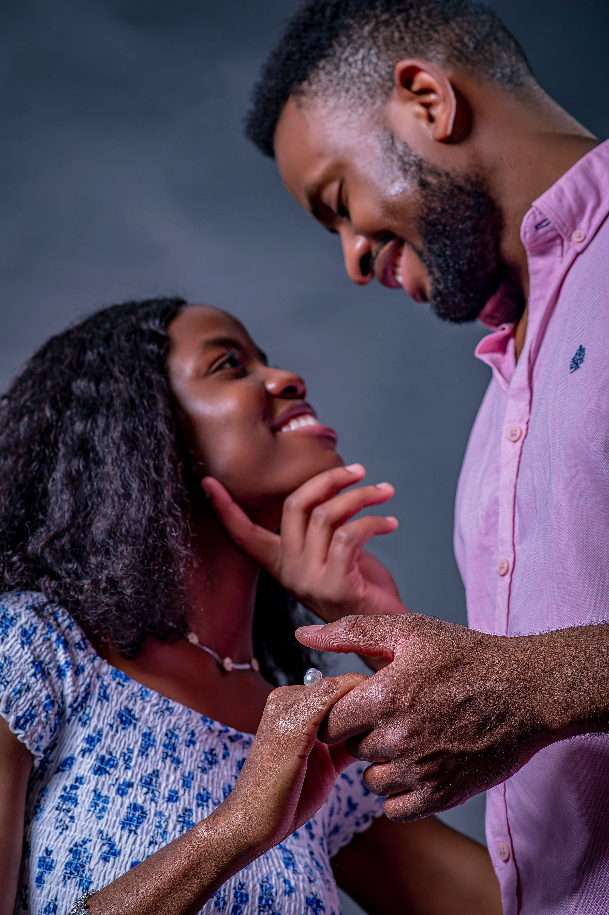 David gently lifting Esther's chin as they share a close look