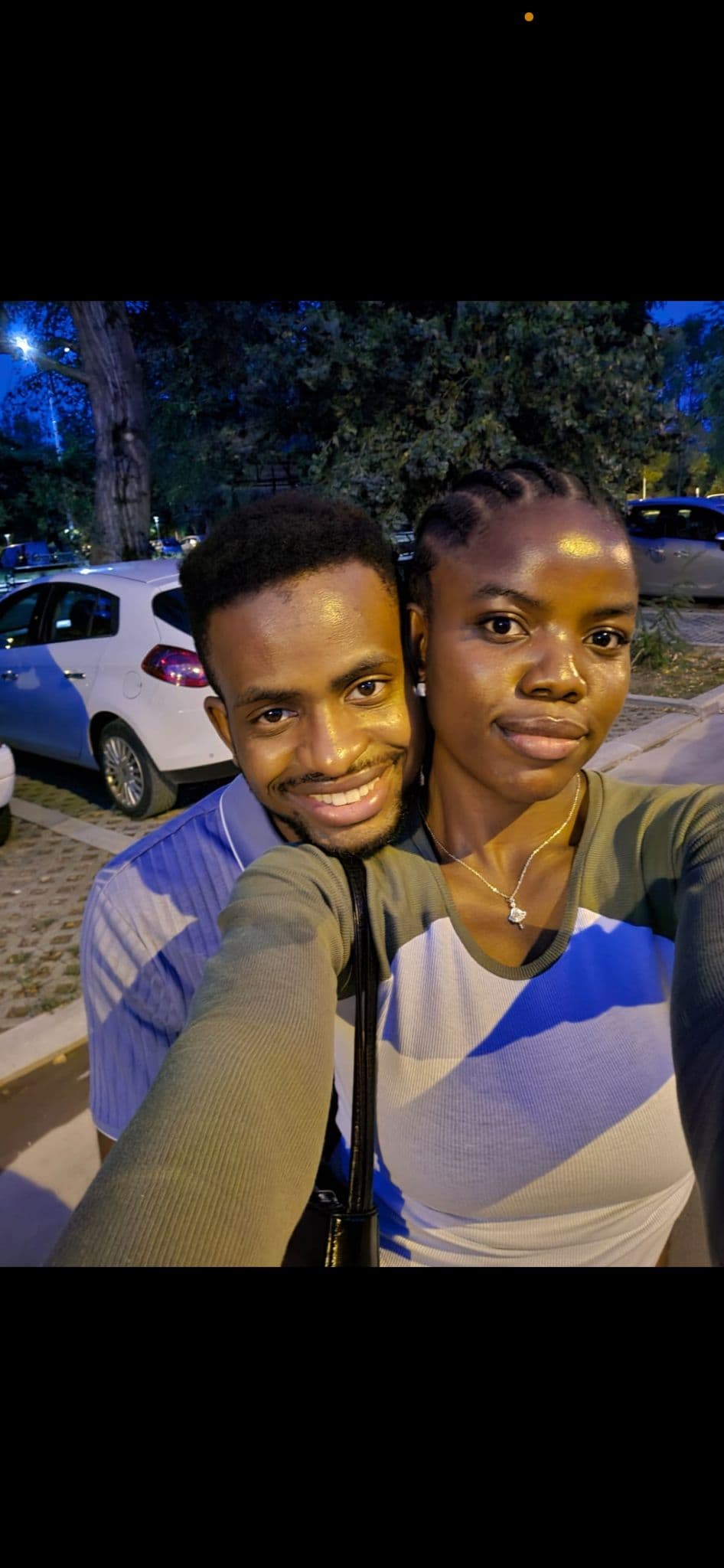 David and Esther taking a night selfie outdoors